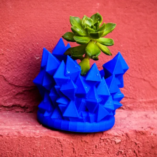 An abstract geometric succulent planter with a unique and modern design, perfect for cacti, succulents, and small plants. A stylish and artistic addition to any space.