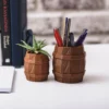 A barrel-shaped aged keg pot, perfect for succulents and pens. A stylish and functional addition to your home or office decor.