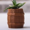 A barrel-shaped aged keg pot, perfect for succulents and pens. A stylish and functional addition to your home or office decor.