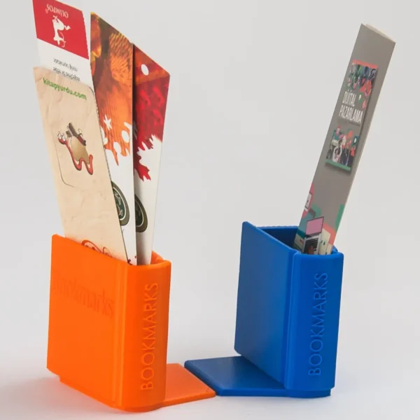 A book-shaped bookend that doubles as a storage organizer for bookmarks, pens, and small desk accessories, perfect for book lovers and office decor.