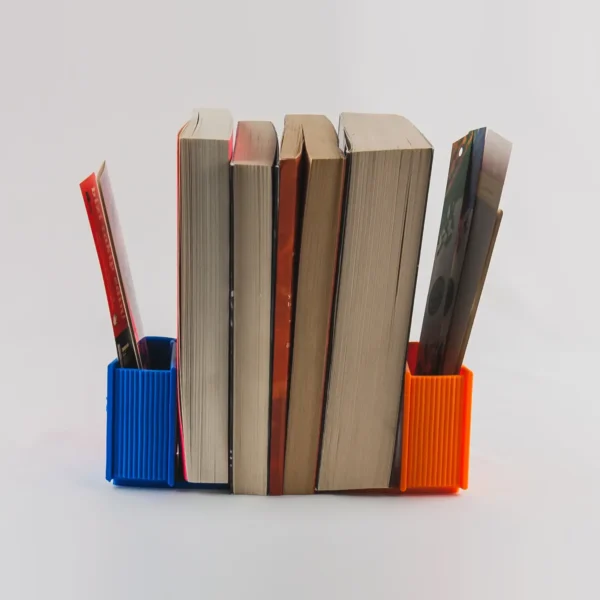 A book-shaped bookend that doubles as a storage organizer for bookmarks, pens, and small desk accessories, perfect for book lovers and office decor.