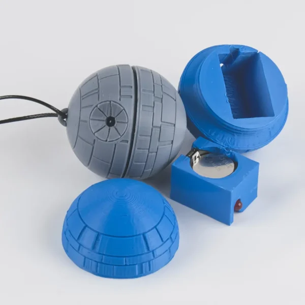 A Star Wars Death Star ornament with a twist mechanism that activates an LED light. Perfect for adding a galactic touch to your Christmas tree.