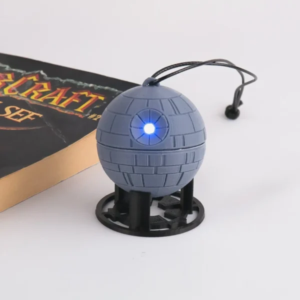 A Star Wars Death Star ornament with a twist mechanism that activates an LED light. Perfect for adding a galactic touch to your Christmas tree.