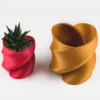 A twisted heart-shaped planter that doubles as a pen or brush holder, perfect for Valentine's Day gifts and modern home decor.