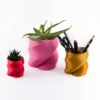 A twisted heart-shaped planter that doubles as a pen or brush holder, perfect for Valentine's Day gifts and modern home decor.