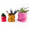 A twisted heart-shaped planter that doubles as a pen or brush holder, perfect for Valentine's Day gifts and modern home decor.