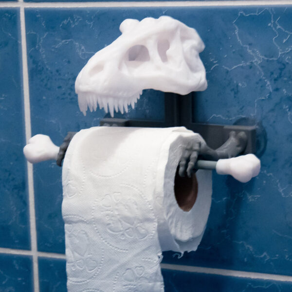 A wall-mounted T-Rex skull toilet paper holder, perfect for adding a unique and functional touch to your bathroom decor.